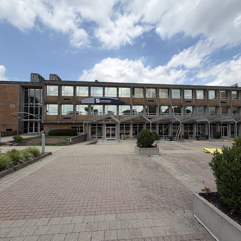 Before — Brick and precast facade with entry plaza at a school campus, building washing by Shine