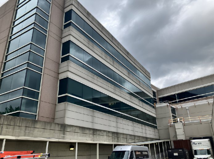 Before — Precast concrete banding on a multi-story office elevation, building washing by Shine