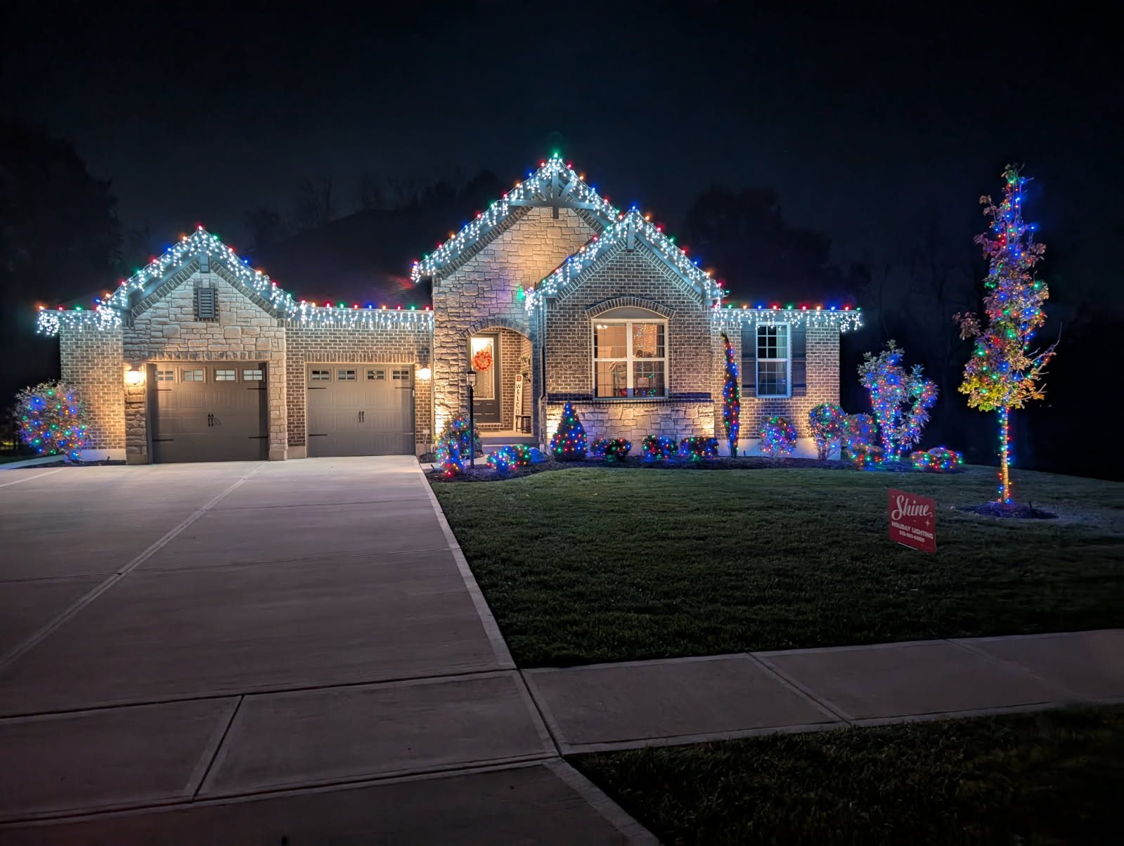 Multicolor roofline, landscape and wrapped tree lighting — holiday lighting by Shine in Cincinnati