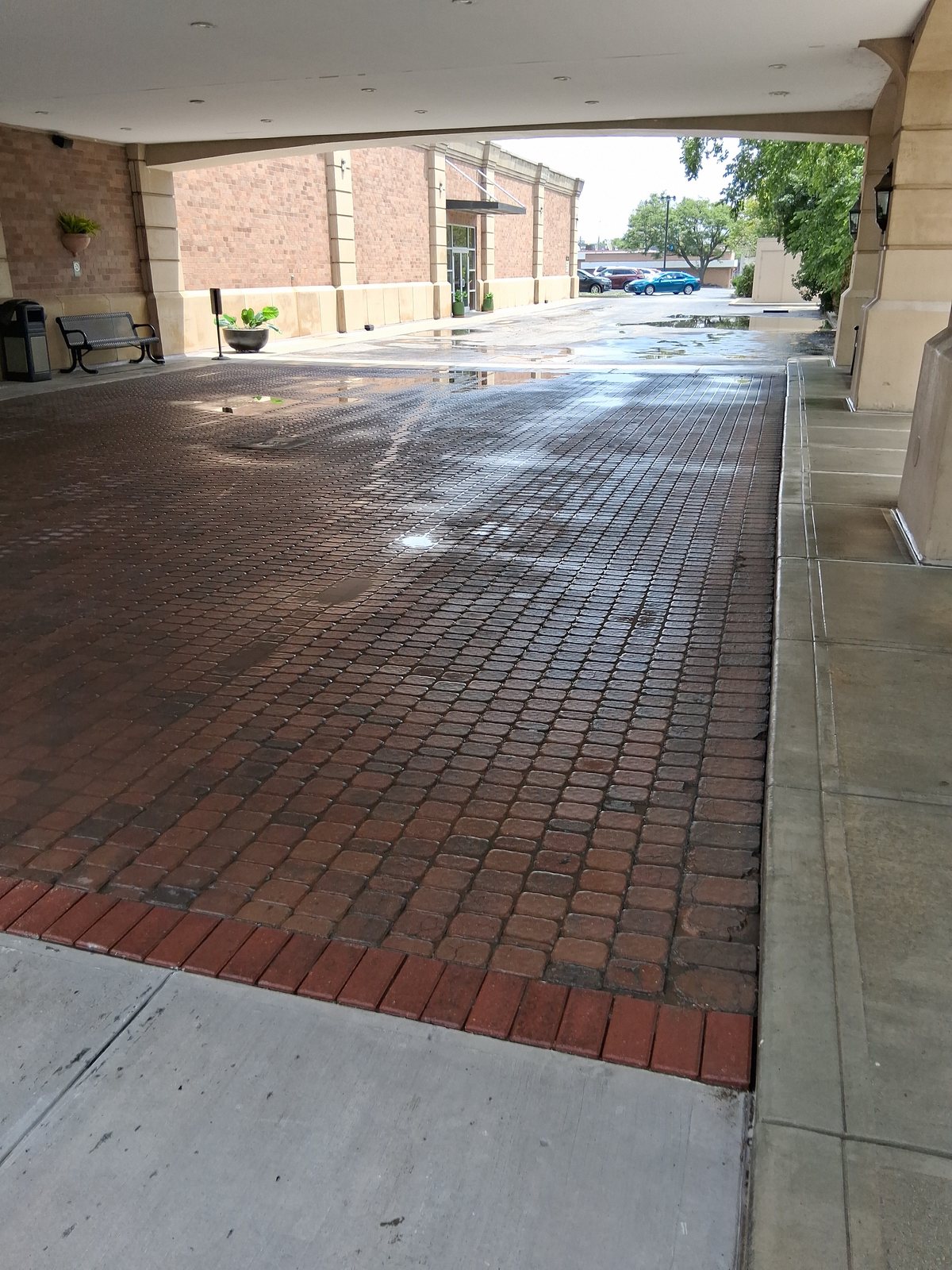 After — Brick paver porte-cochere at a hotel entrance, flat surface pressure washing by Shine