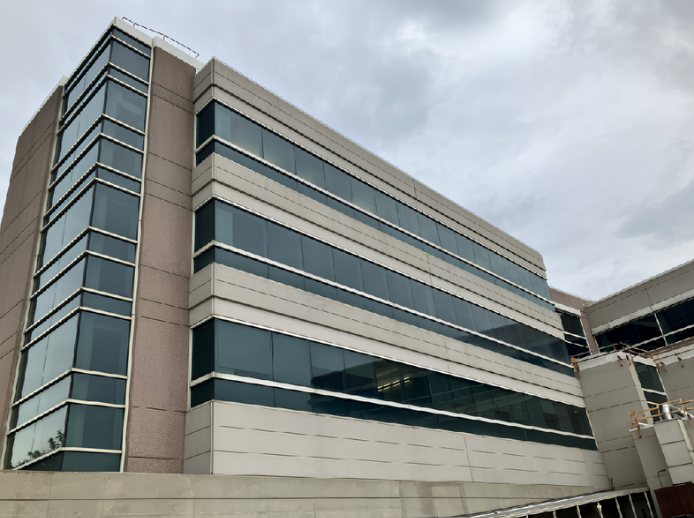 After — Precast concrete banding on a multi-story office elevation, building washing by Shine