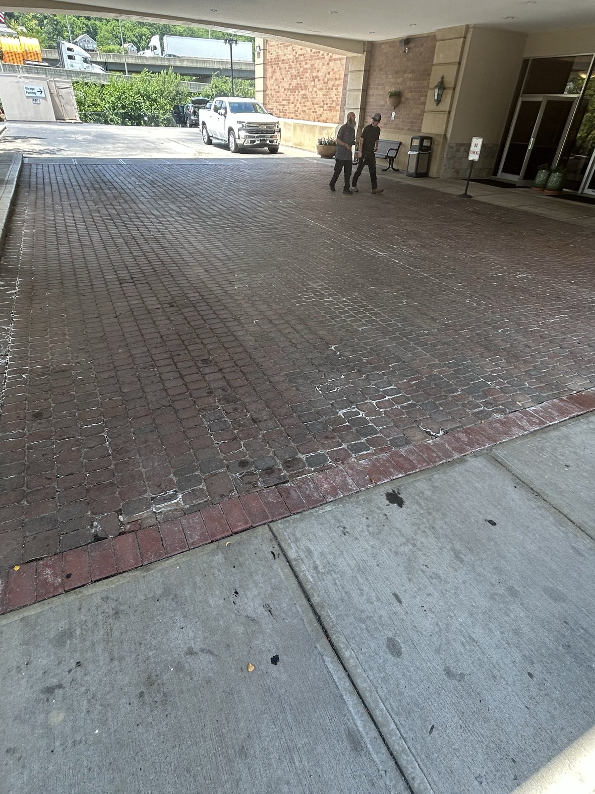 Before — Brick paver porte-cochere at a hotel entrance, flat surface pressure washing by Shine