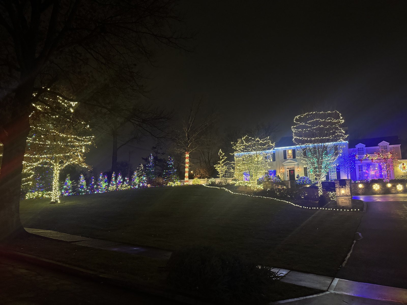 Wrapped trees and landscape lighting across a larger property — holiday lighting by Shine in Cincinnati