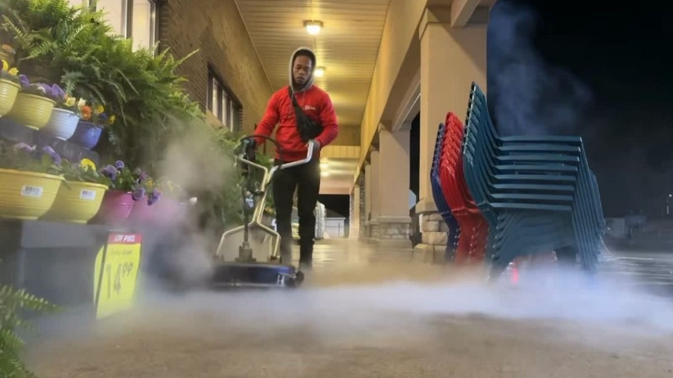 Hot-water surface cleaner running a retail sidewalk after close — recurring site maintenance by Shine