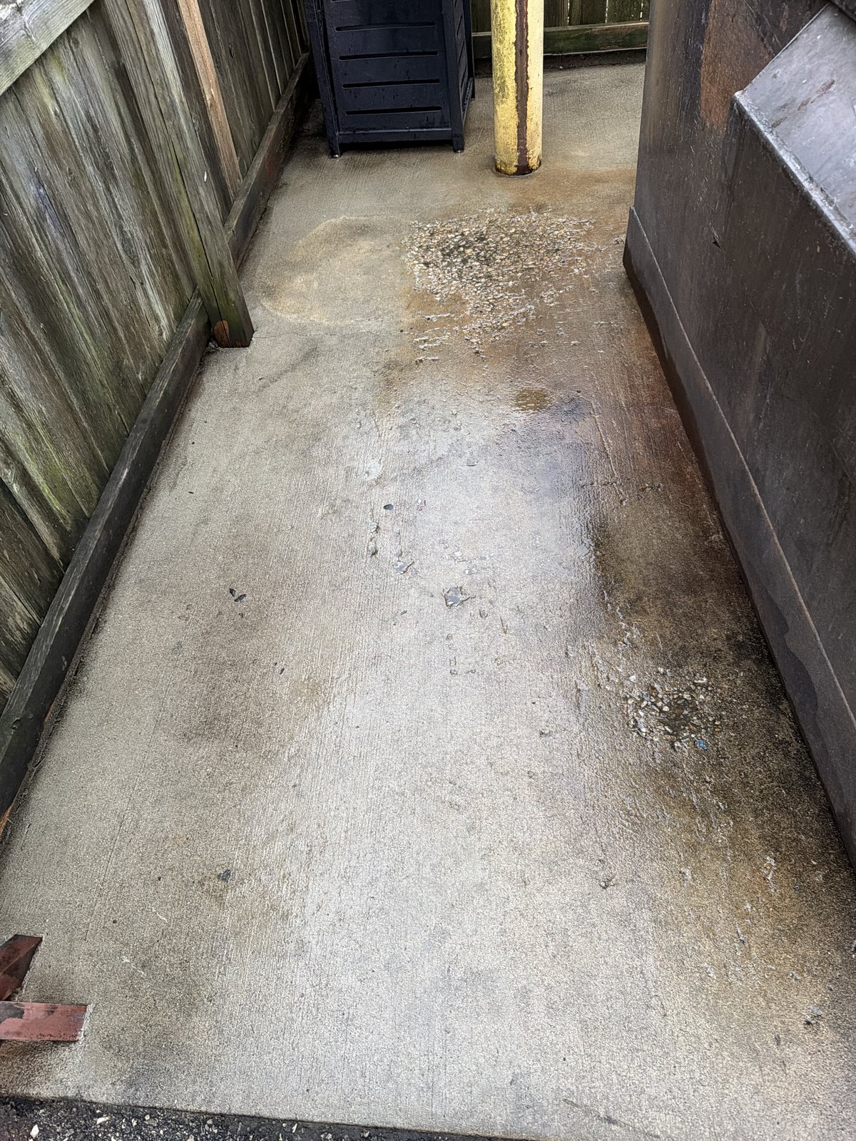 Before — Dumpster pad enclosure, grease and debris removed, recurring site maintenance by Shine