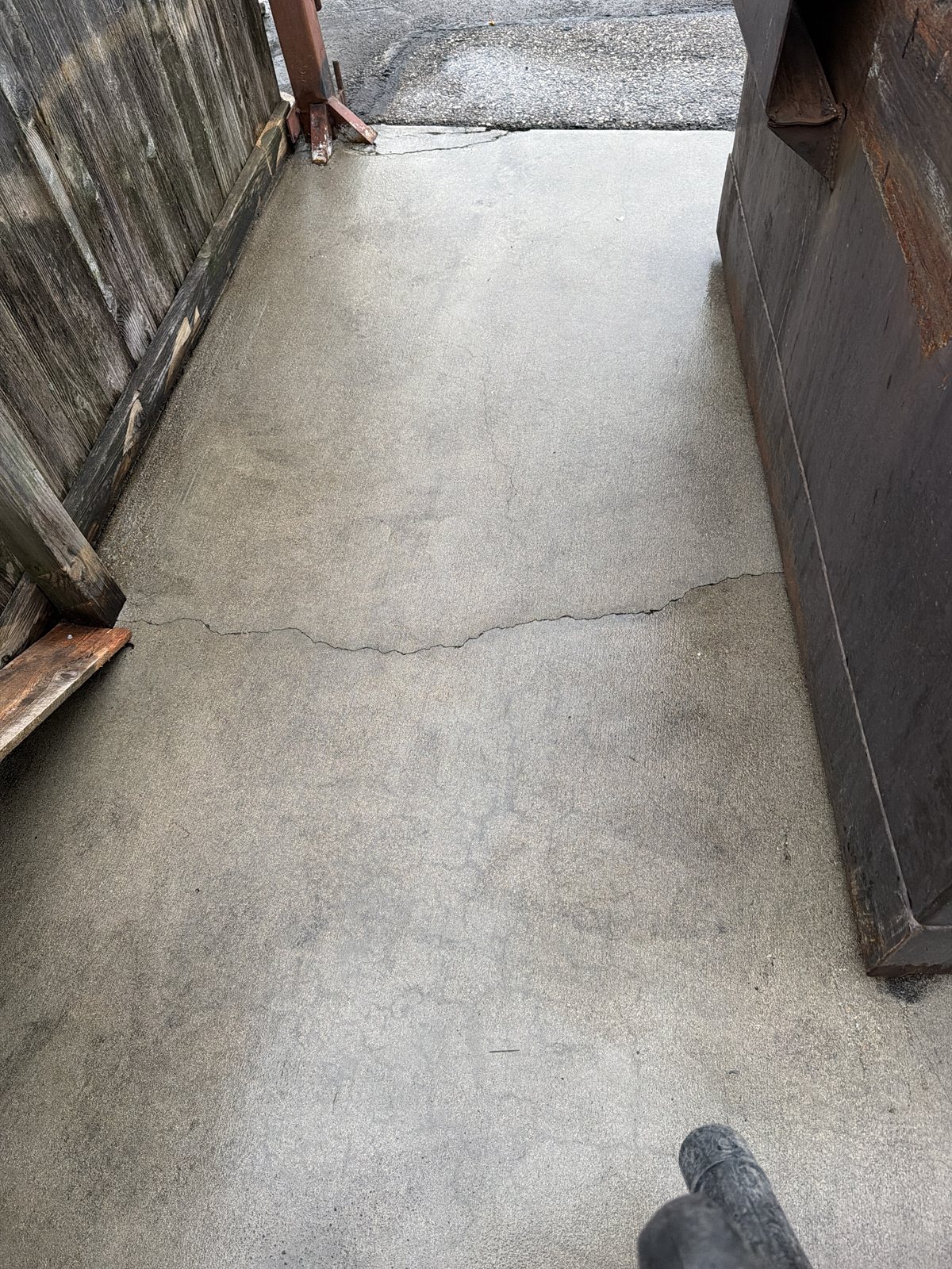 After — Dumpster pad enclosure, grease and debris removed, recurring site maintenance by Shine